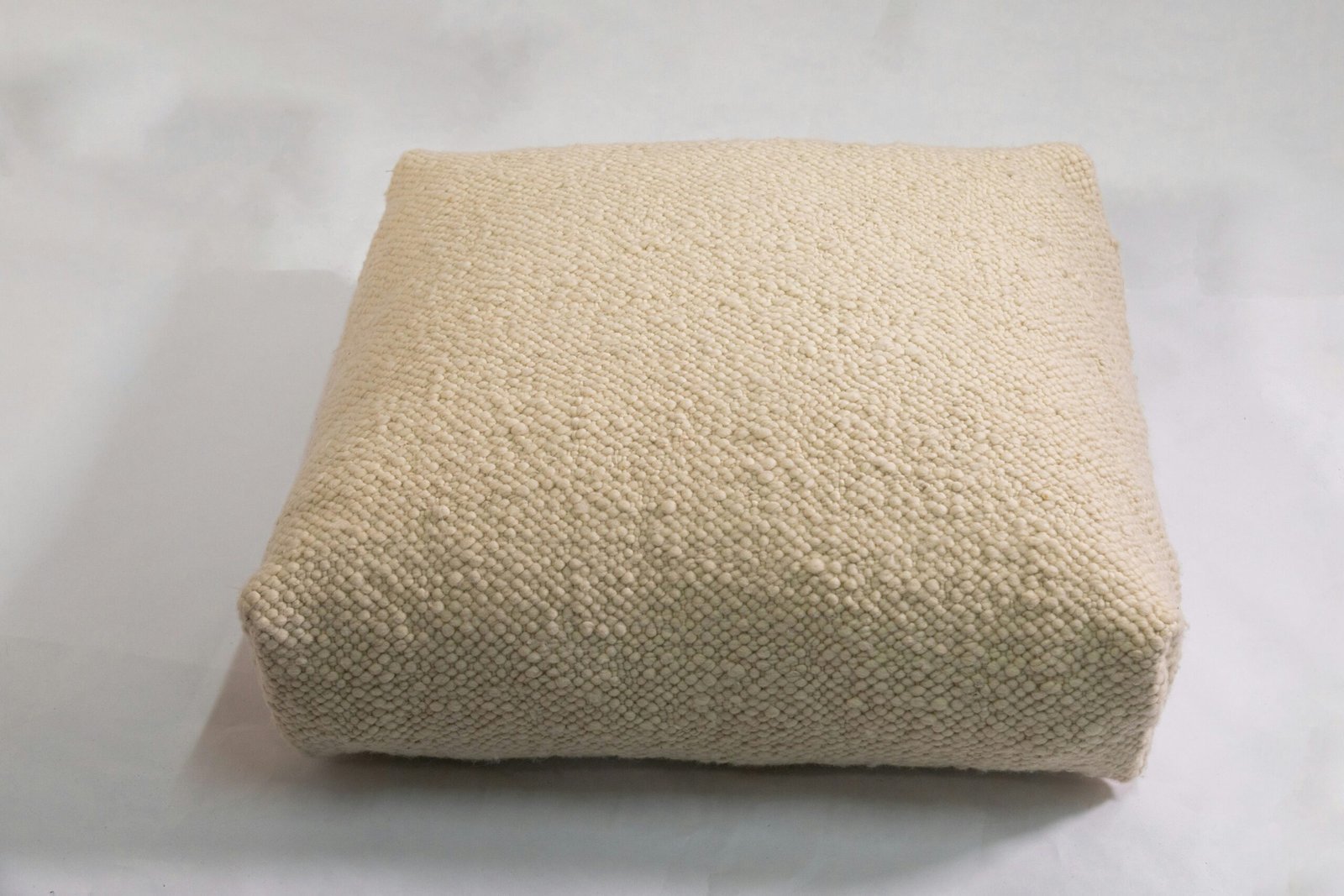 a close up of a pillow on a white surface